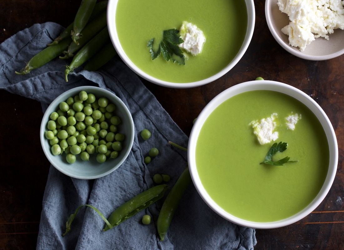 Vue aérienne de bols de soupe de pois cassés verts avec garniture de pois frais